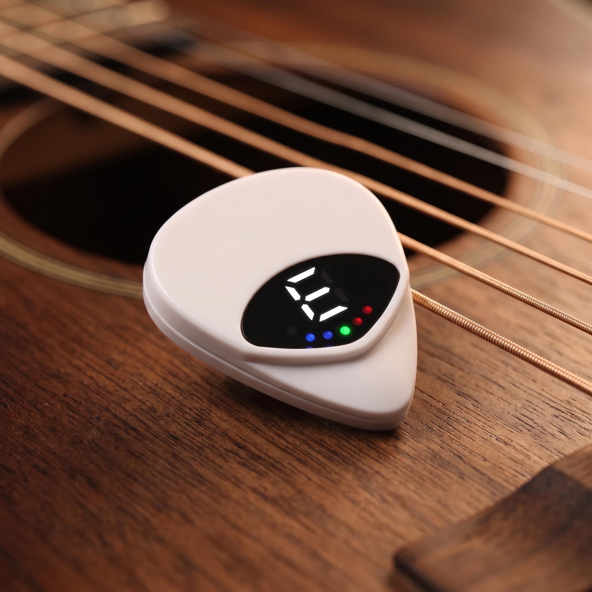 Close-up of the white triangular Chordwell pick tuner and black display