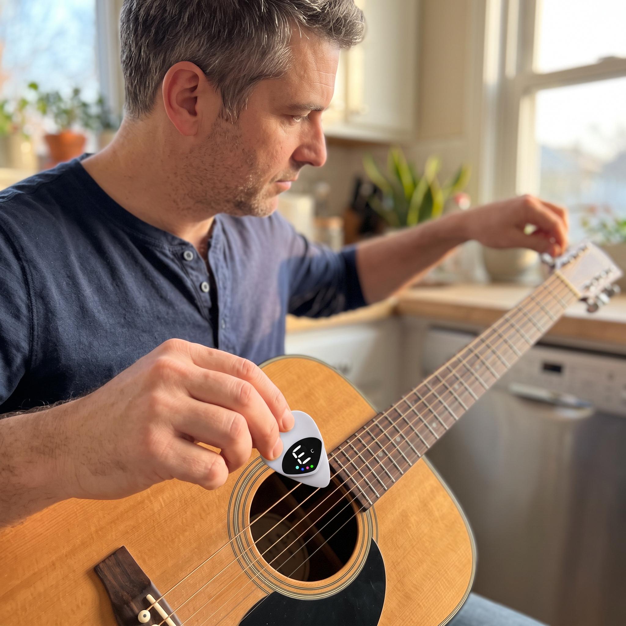 White Chordwell pick tuner ready beside an acoustic guitar