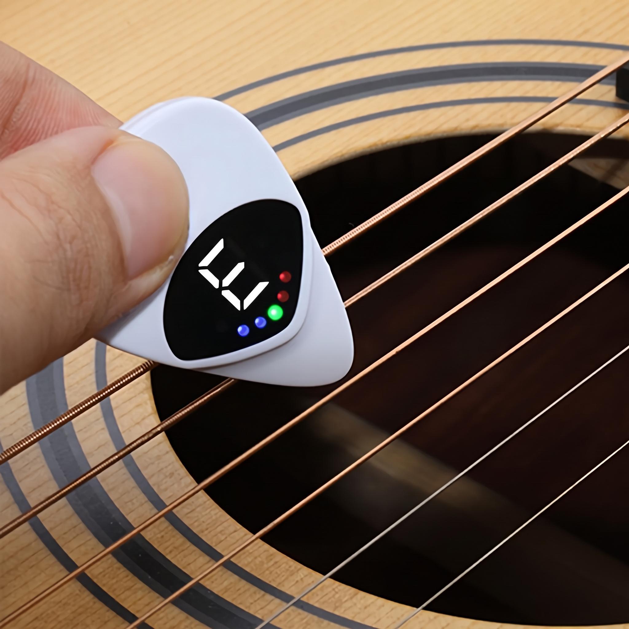 White pick tuner beside sheet music